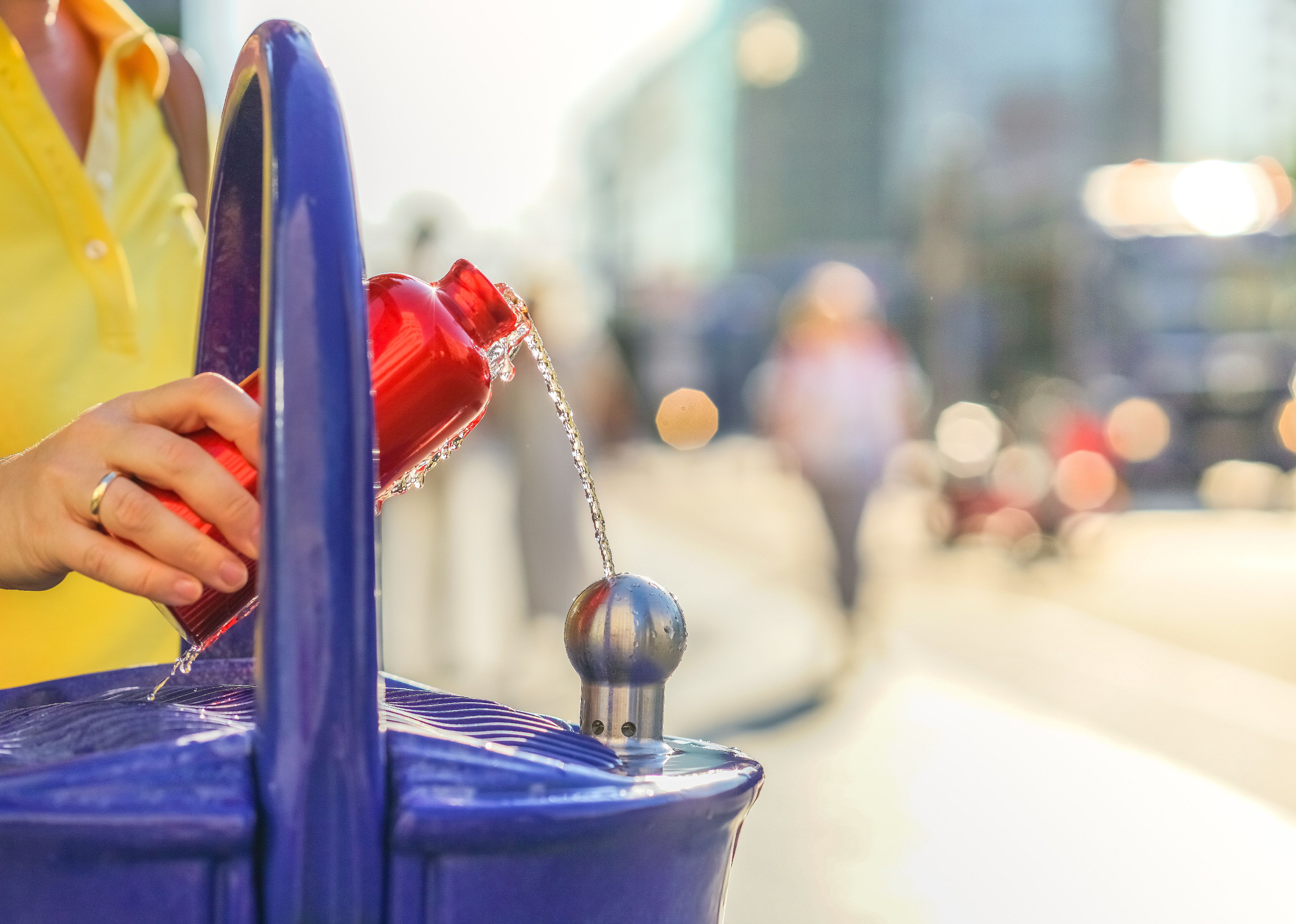 Traveler refills a bottle of drinking water