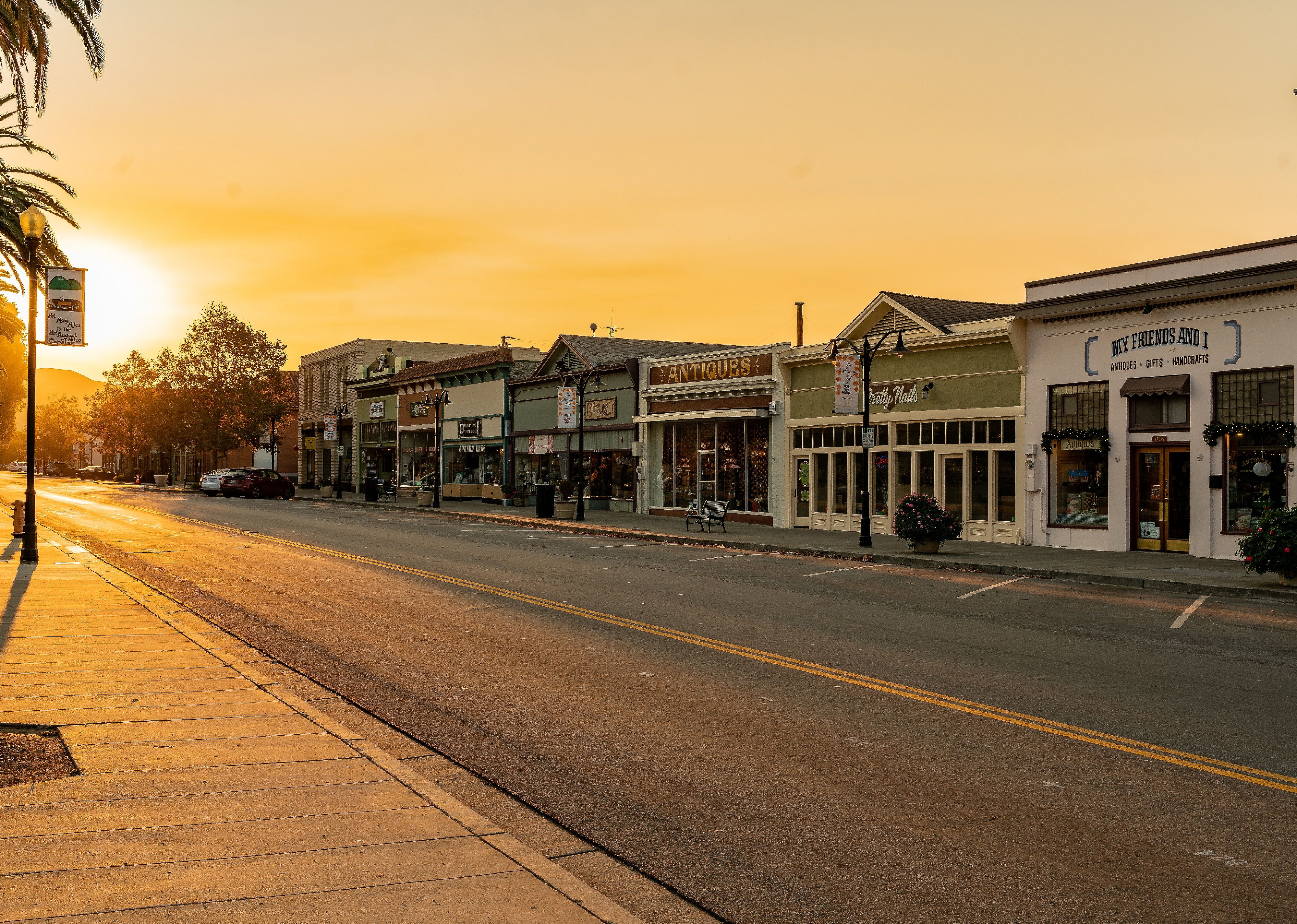 Sunset over an empty road and store fronts