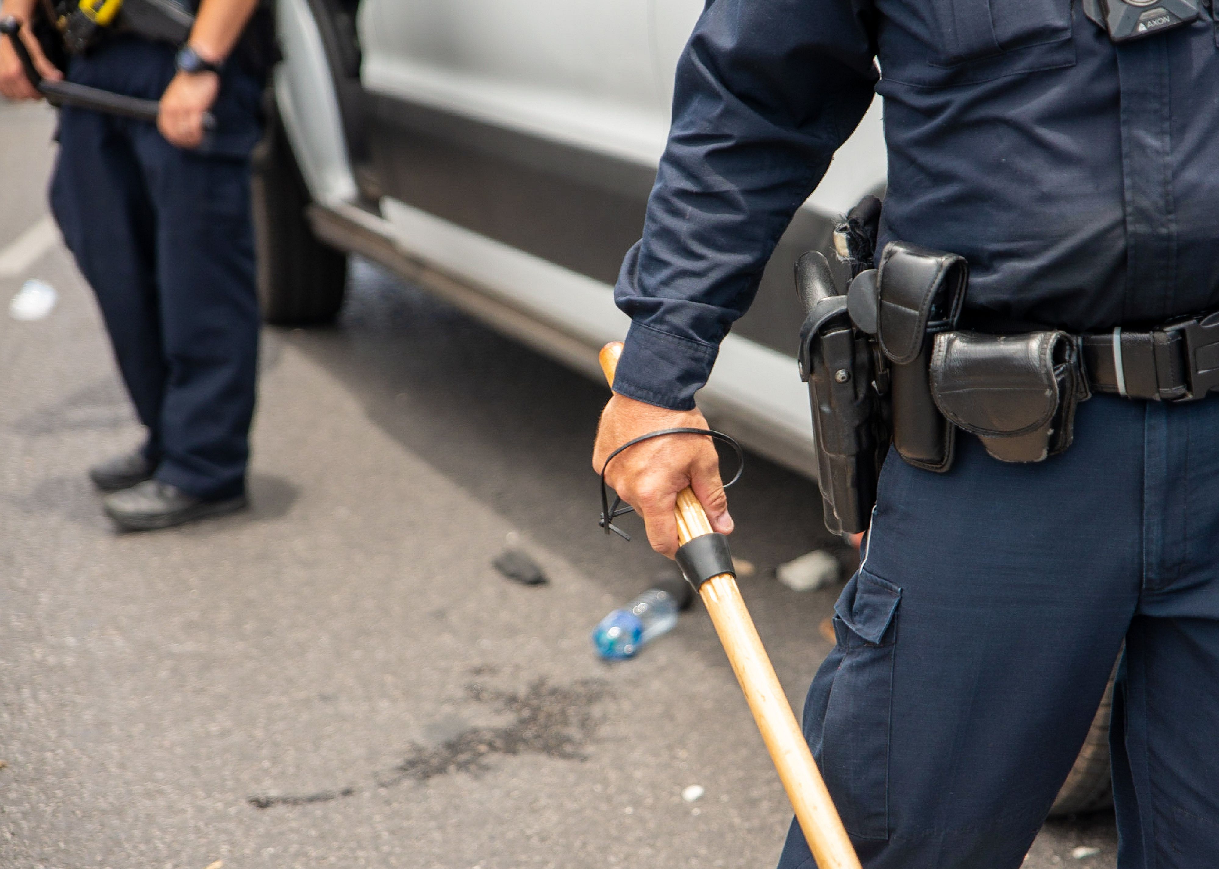 A police officer watches protesters.