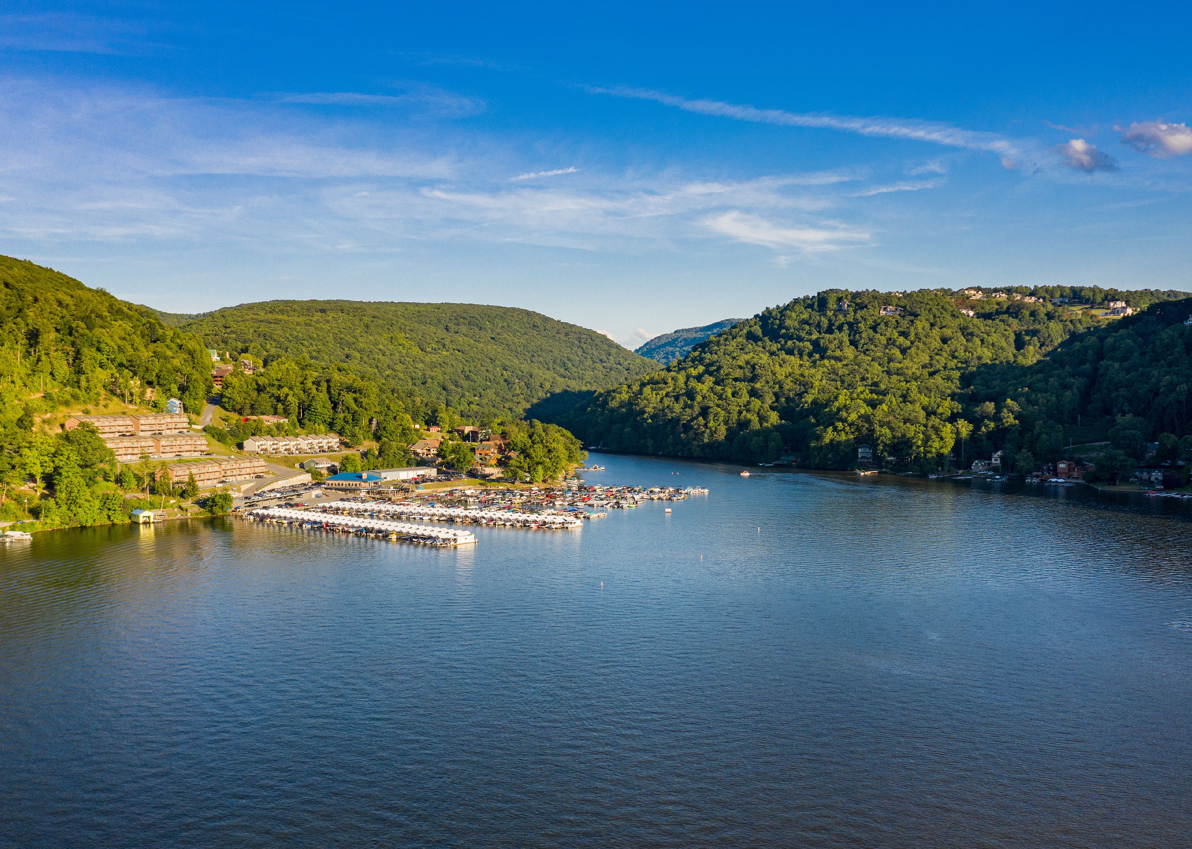 Aerial view of townhouses and marina on lake.