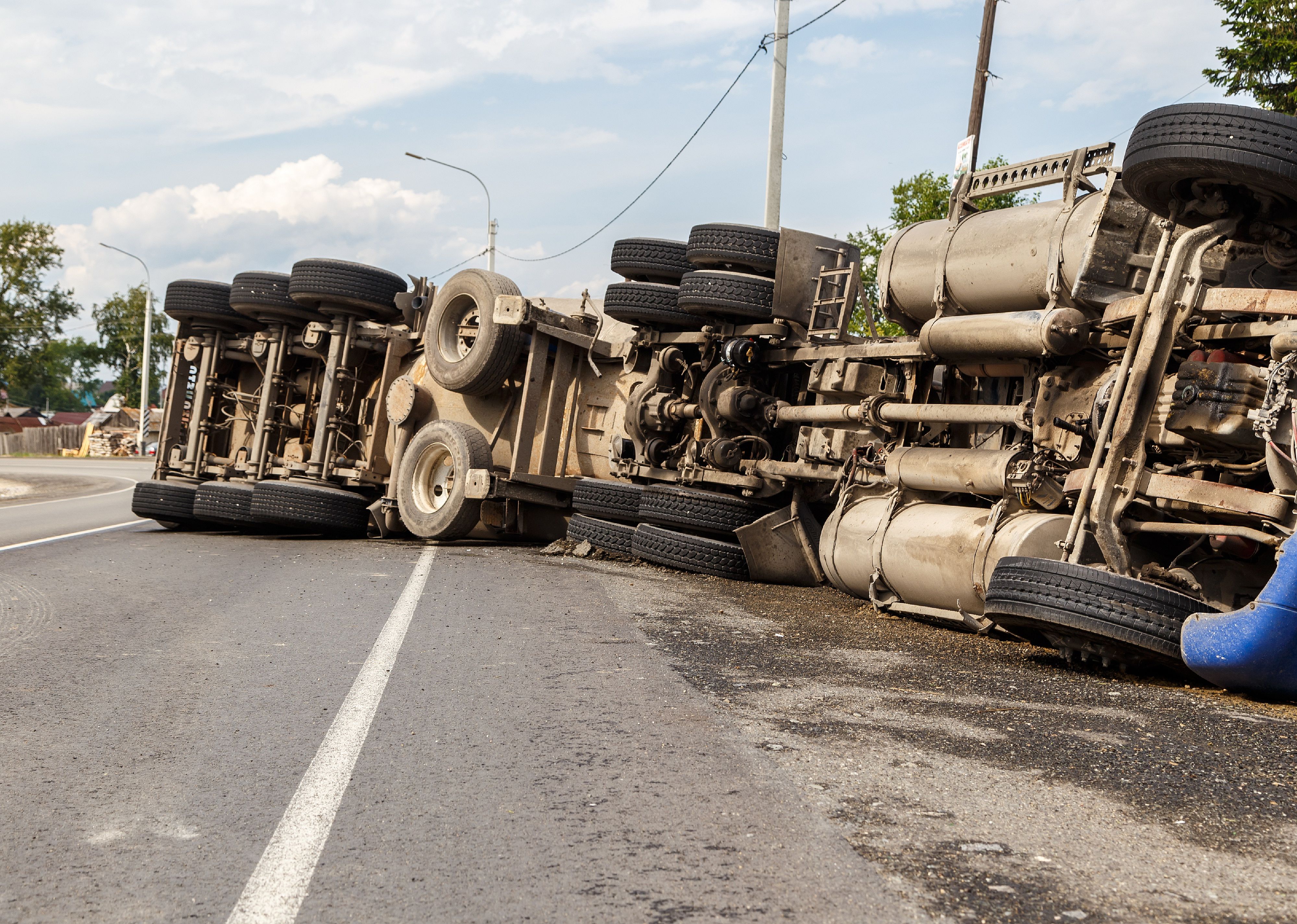 A view of an overturned truck on an highway