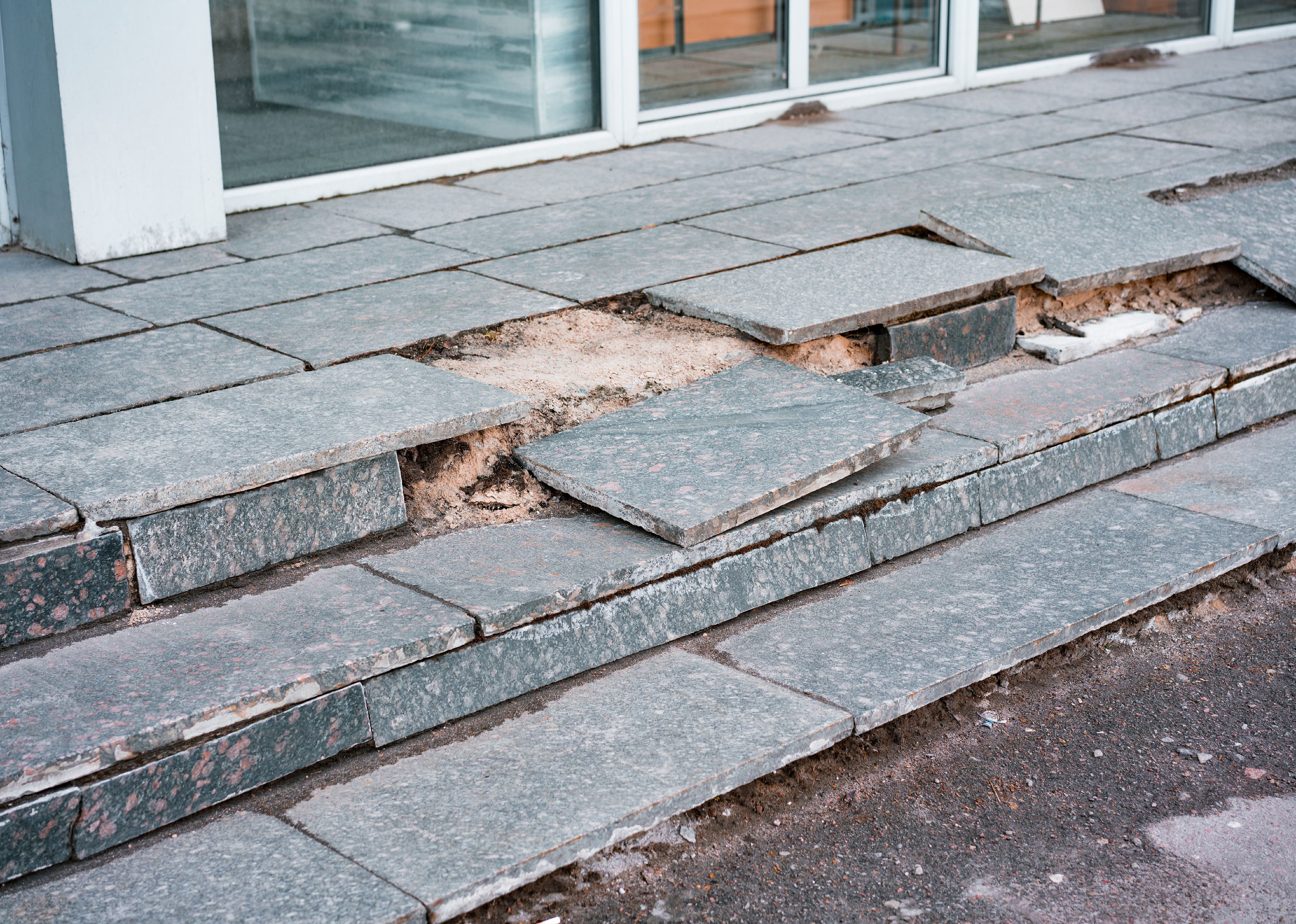 Outdoor broken tile stairs near a building.