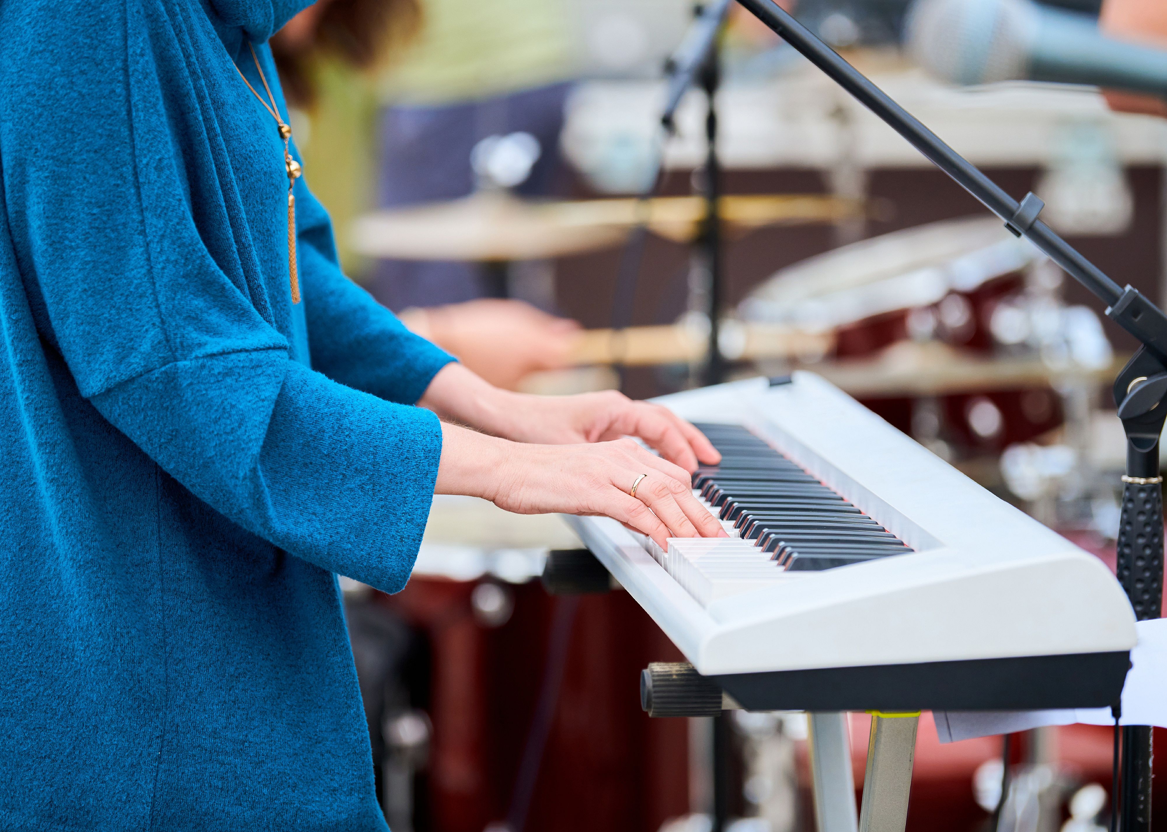 Musician playing synthesizer on concert stage