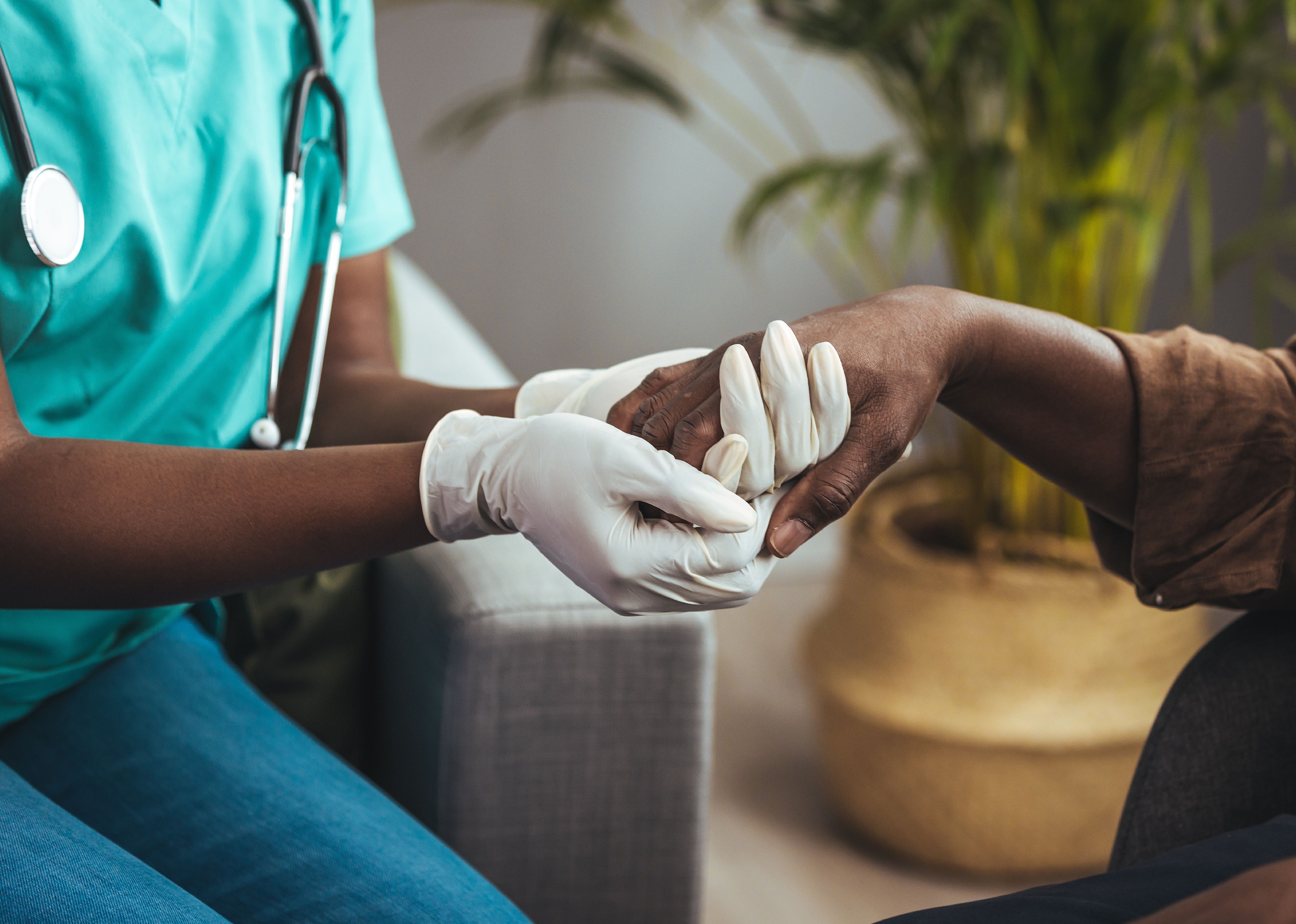 Nurse holding the hand of an elderly patient.