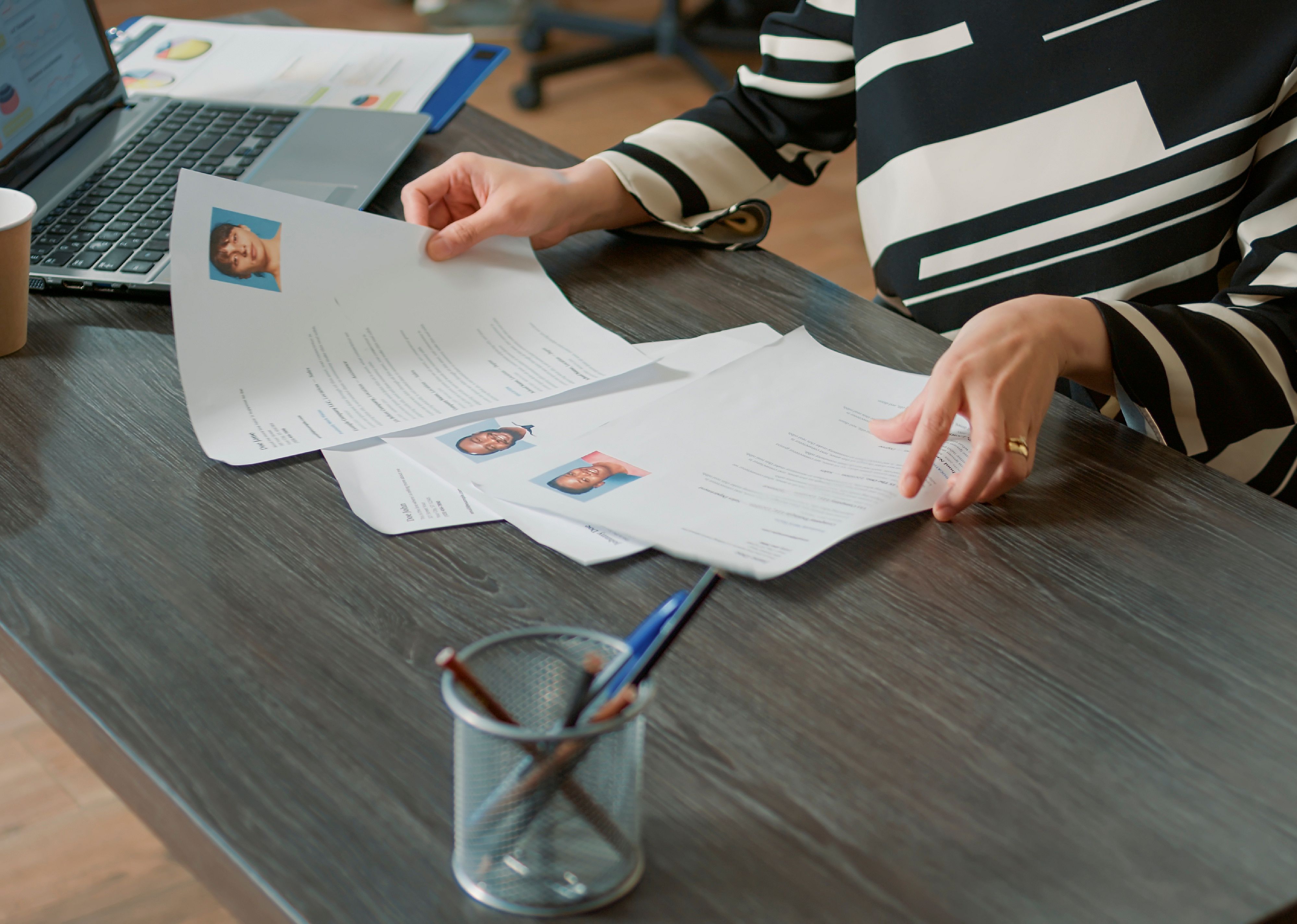 Close up of a woman reviewing CVs