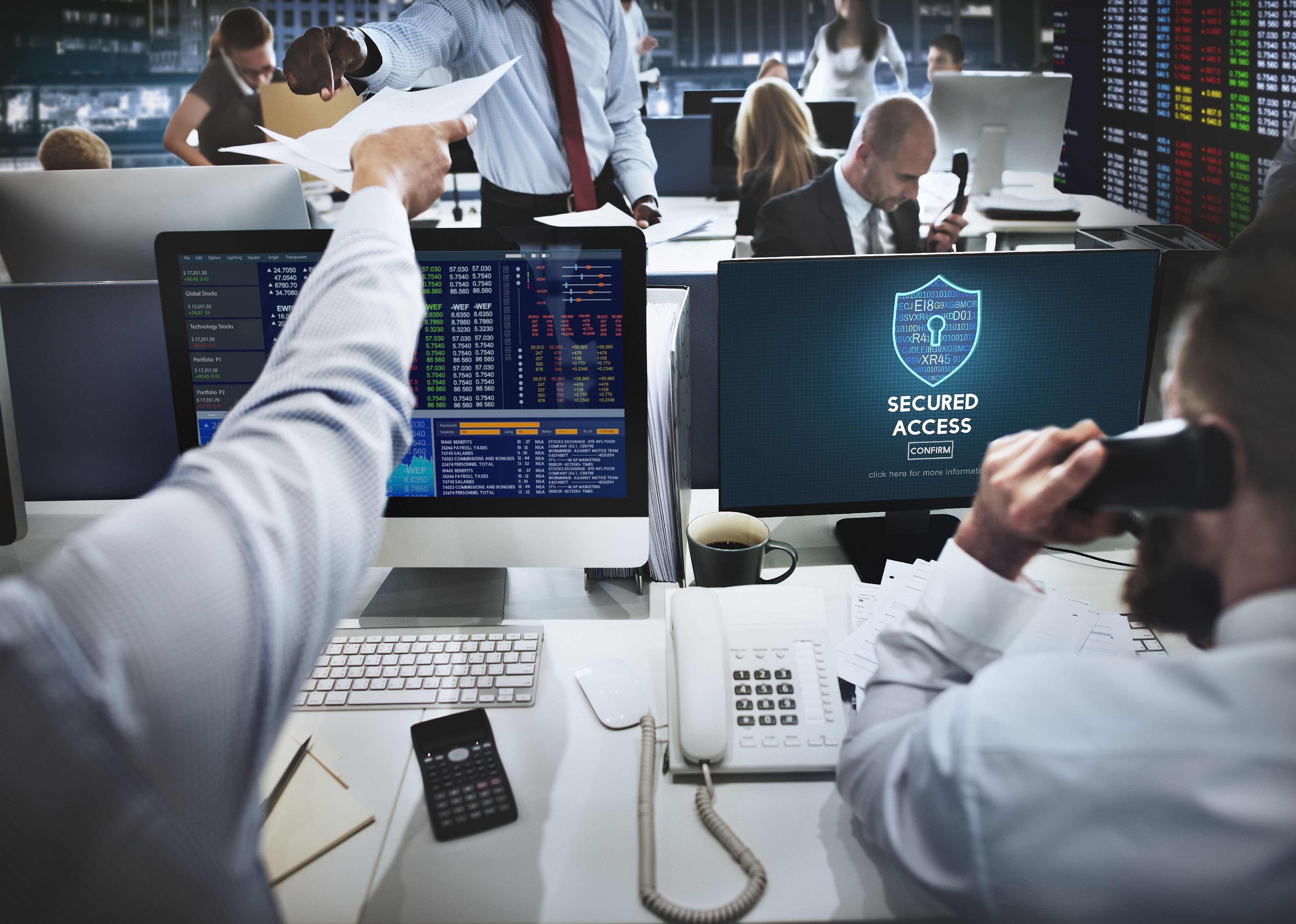 Workers around security and data monitors 