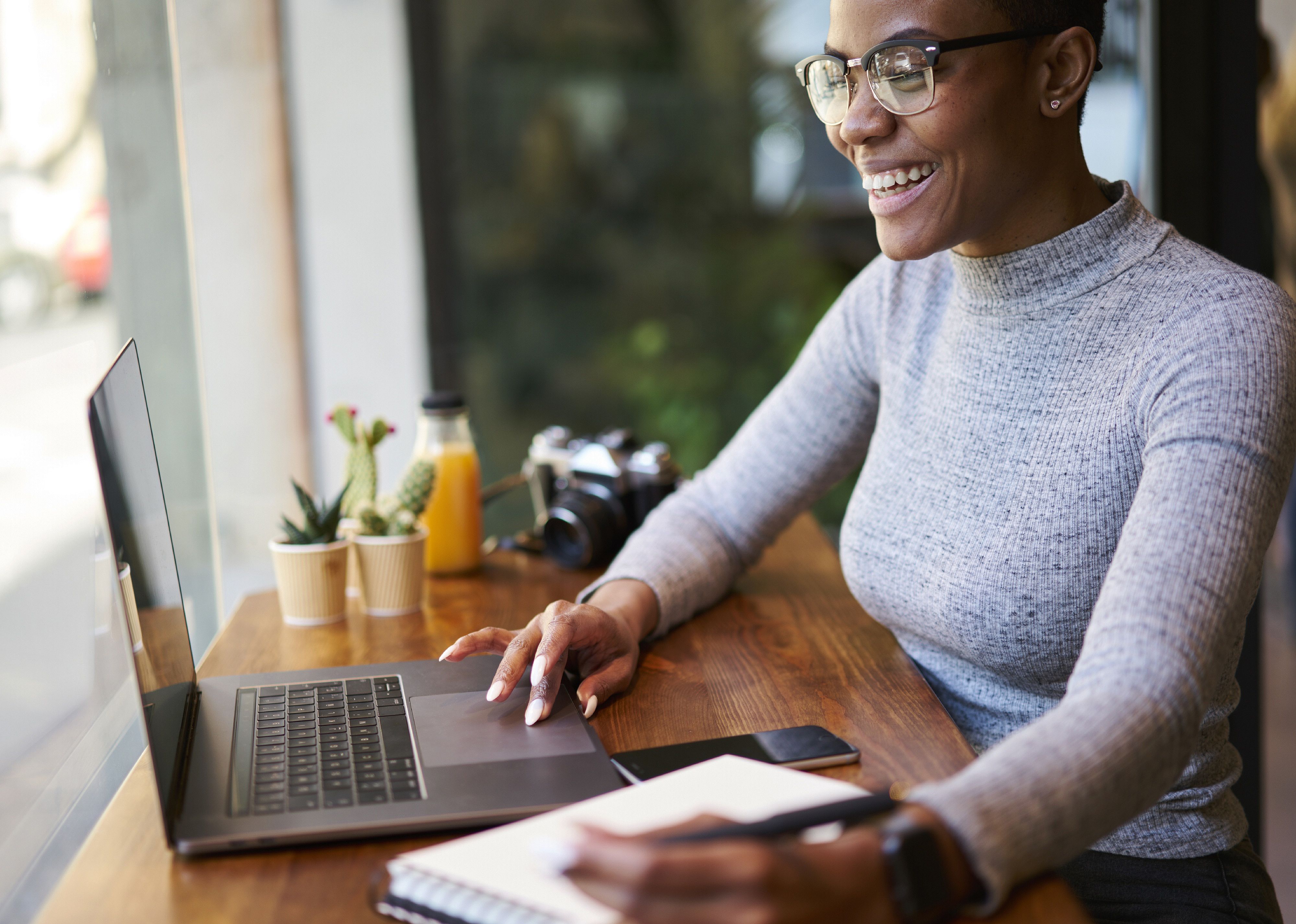 Smiling female communicating with others via video chat