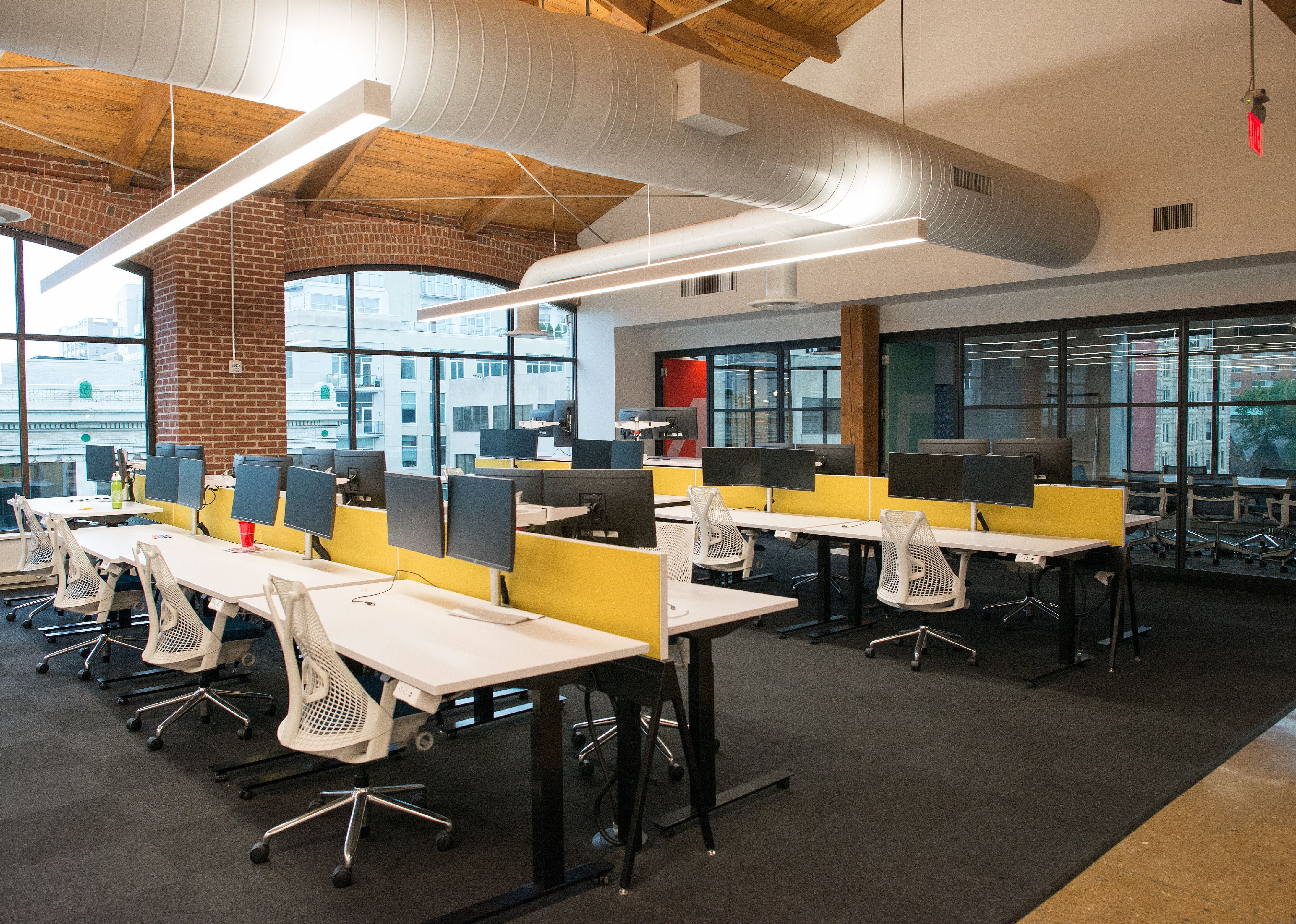 Trendy modern open concept loft office space with big windows.