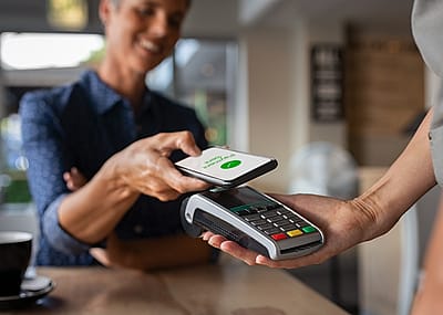Woman paying bill with smartphone