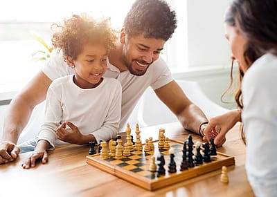 Family playing chess together.