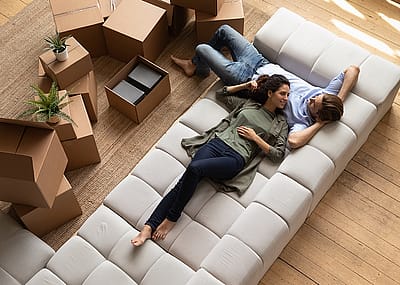 Overhead view of a couple relaxing on new sofa.