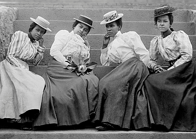 Four Black women sitting on steps of Atlanta University.