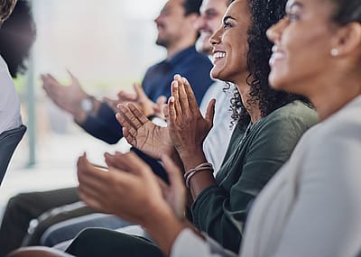Group of businesspeople applauding during seminar.