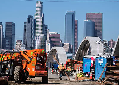 Road construction with Los Angeles skyline.