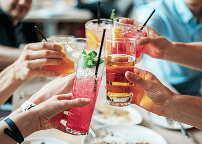 Friends toasting with drinks.