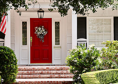 House with red door and American flag.