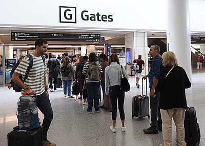 Travelers line up to enter a security checkpoint in the international terminal at San Francisco International Airport on July 01, 2022 in San Francisco, California.