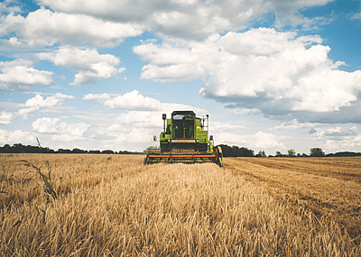 Tractor moves across dry field