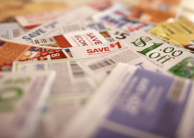 A pile of coupons on a table.