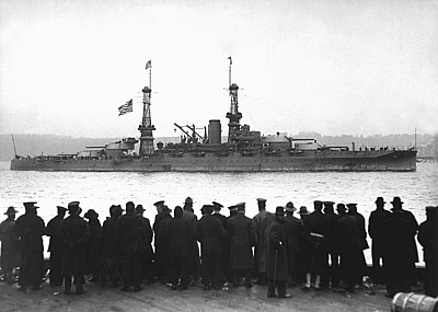 View of crowds gathered at the 96th Street Pier to watch the USS Arizona leading the fleet in a naval review for Secretary of the Navy Josephus Daniels, upon the fleet's arrival home at the end of the First World War, NY December 1918.