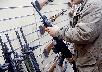 Man with an automatic rifle at the store.