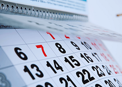 A calendar with red and black dates.