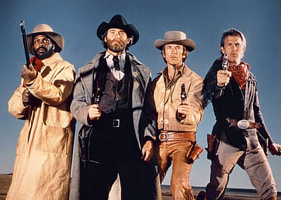 Actors Danny Glover, Kevin Kline, Scott Glenn, and Kevin Costner on the set of 'Silverado.'