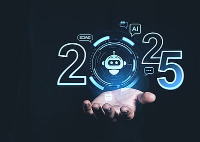 A person holding up a digital display showing AI trends for 2025.