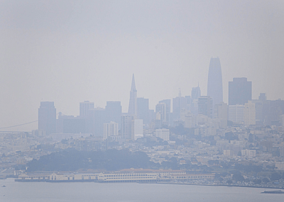 Smoke from wildfires causes hazy conditions over San Francisco skyline on sunny day