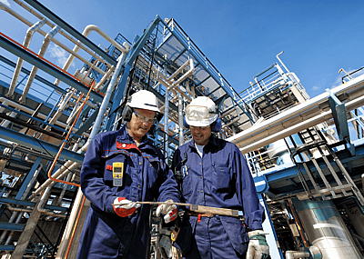Two workers at an oil refinery plant