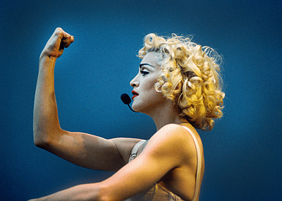 Madonna performing on stage during the Blonde Ambition tour, wearing a Jean Paul Goltier conical bra corset