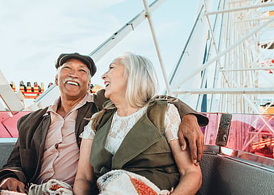 Cheerful senior couple enjoying a ferris wheel by the Santa Monica pier.