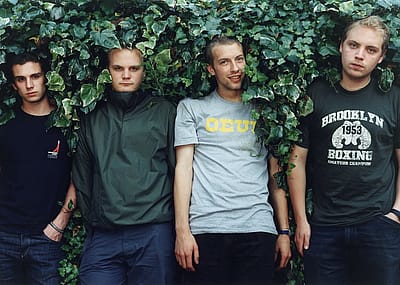Coldplay pose for a group portrait in the UK, July 1. (L–R) Guy Berryman, Will Champion, Chris Martin, and Jonny Buckland.