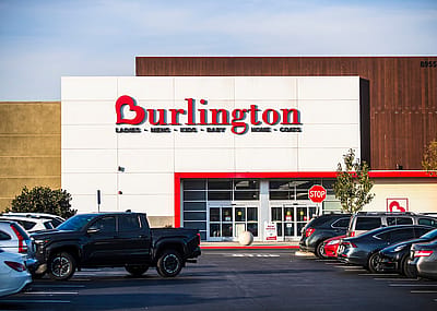 A Los Angeles Burlington retail store exterior with a parking lot in the foreground under clear skies.