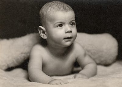 Small baby lying prone position, circa 1950s.