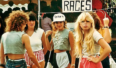 Four women hanging out at a county fair in 1983.