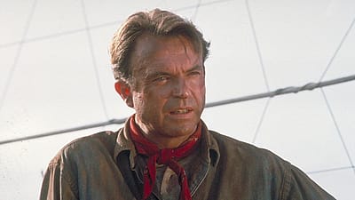 Actor Sam Neill as Dr. Alan Grant, next to an electric fence in a scene from the film 'Jurassic Park', 1993.