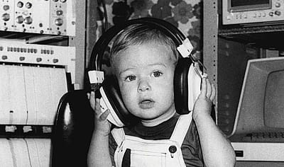 Baby in 1981 wearing headphones during an auditory test.