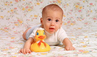 A portrait of a baby boy in the 1970s with his rubber ducky.