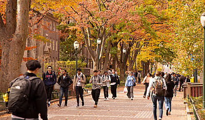 Students walking on campus during the fall