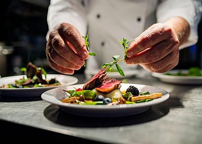 A chef plating a colorful dish.
