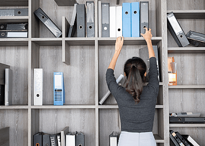 A person organizing their office.