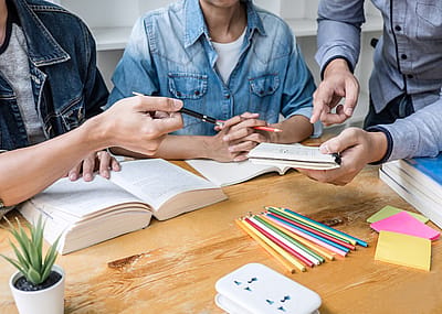 A tutor working with two students.
