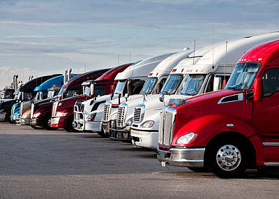 A line of parked semi-trucks at a truck stop in Missouri.