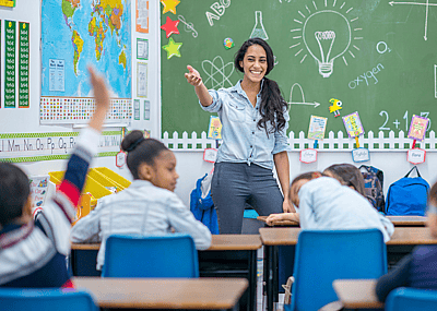 A teacher calling on a student in a classroom.
