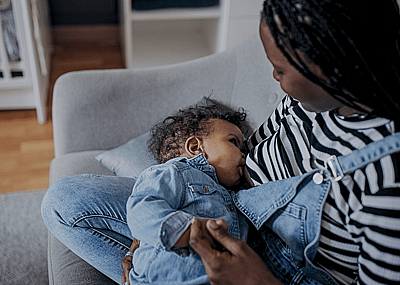 A mother breastfeeds a baby.