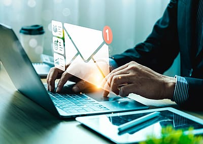 A man checking email on a laptop.