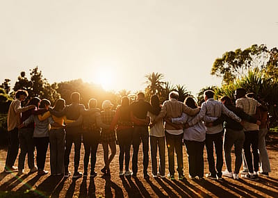 A large family locking arms.