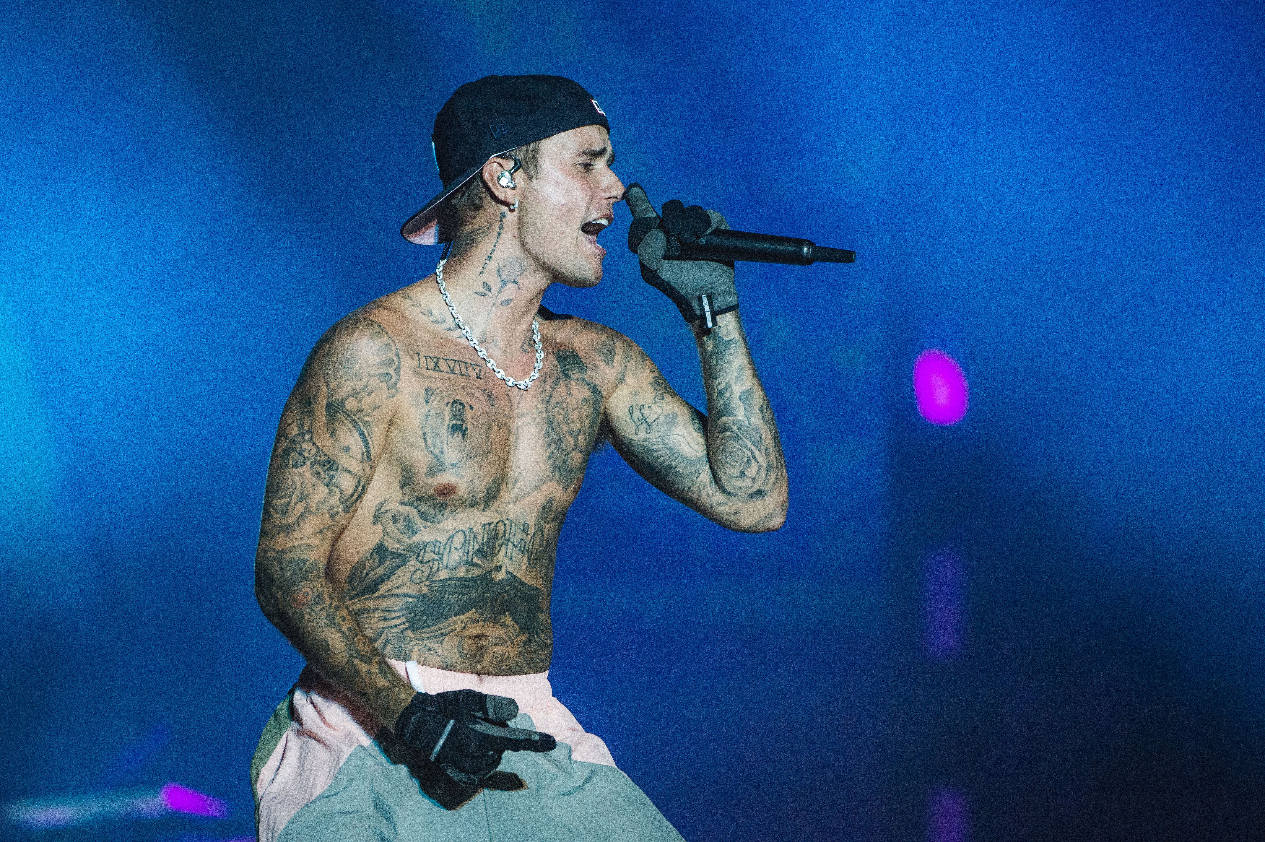 Justin Bieber performing shirtless onstage.