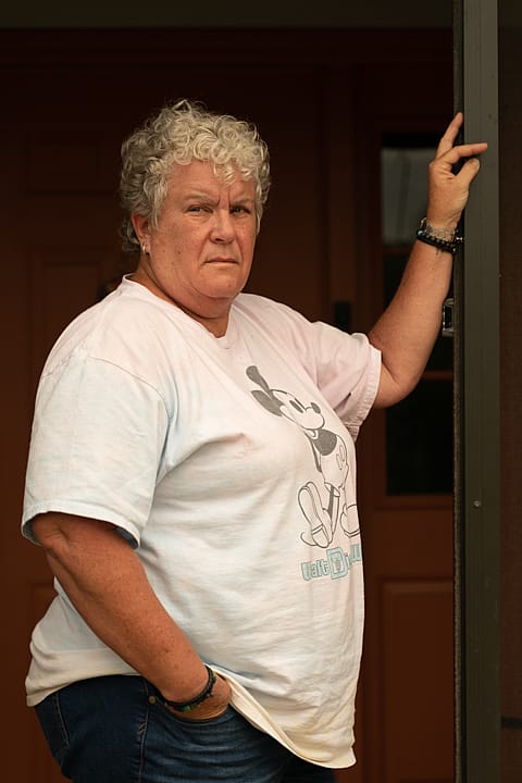 A person stands in a doorway.